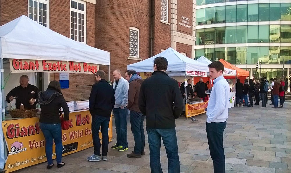 Photo of the team waiting at a food stall.